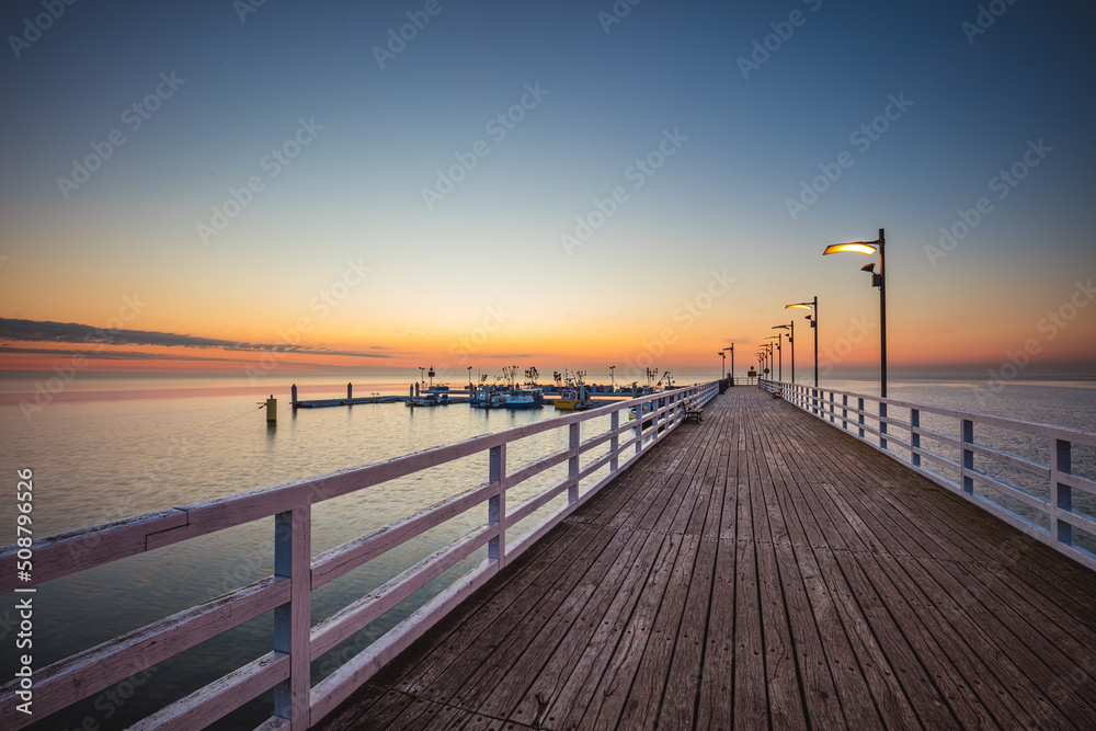 Sunrise over the pier in Mechelinki.