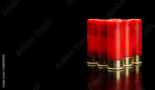 Photography Shotgun shells on a black reflective surface