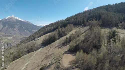 Spruce-covered hills with glimpses of Alpine mountains