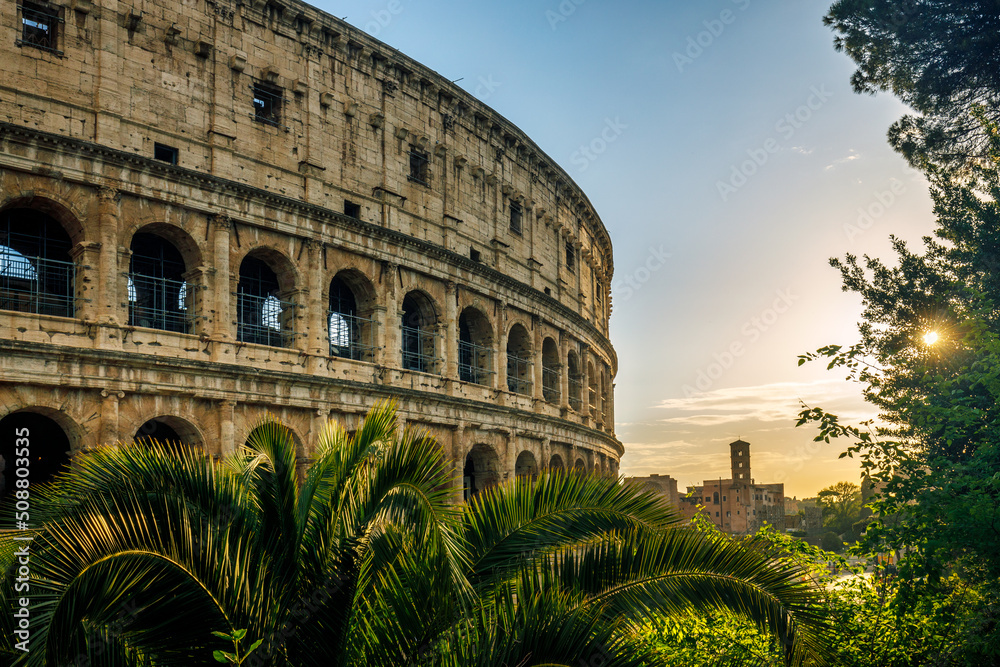 The Colosseum amphitheatre in the centre of the city of Rome at sunset, Italy, Europe.