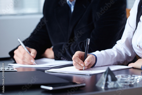 man and woman hands signing contract paper in office