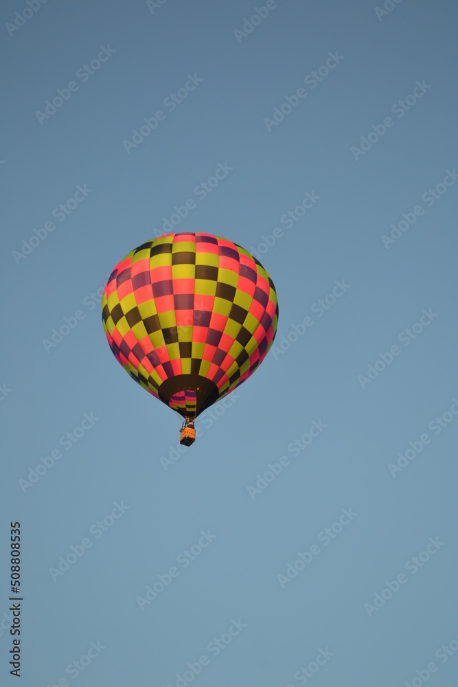 A very colorful hot air balloon flying high in the sky A very colorful hot air balloon flying high in the sky