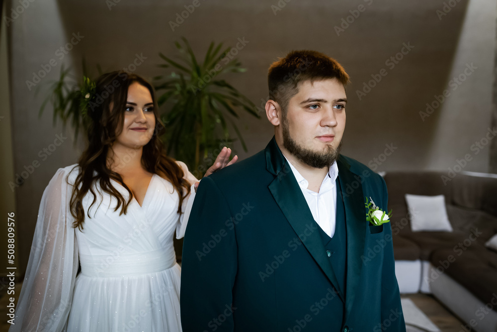 Curvy people, wedding couple on a walk. Stylish charming bride, groom in green suit. Beautiful park Curvy people, wedding couple on a walk. Stylish charming bride, groom in green suit. Beautiful park