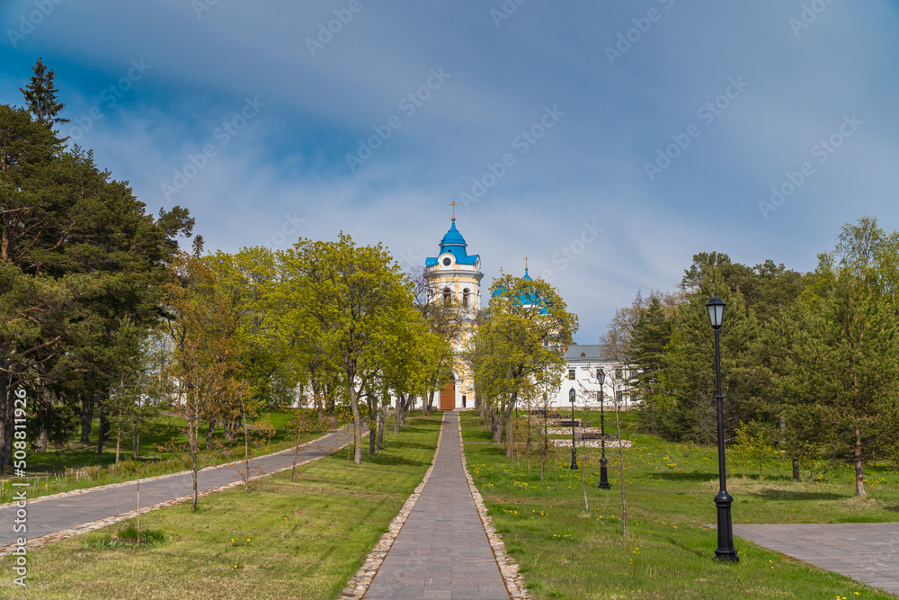 Fototapeta premium Russia. Leningrad region. May 29, 2022. View of the Nativity of the Theotokos Monastery from the territory of Konevets Island.