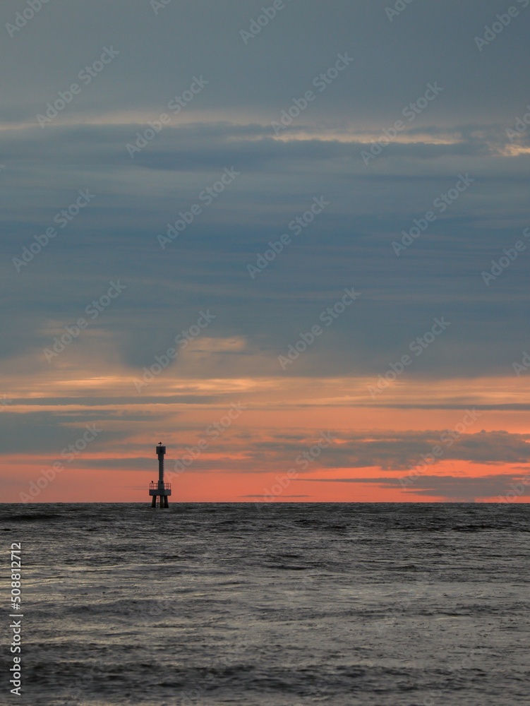 ocean sunset with small light house