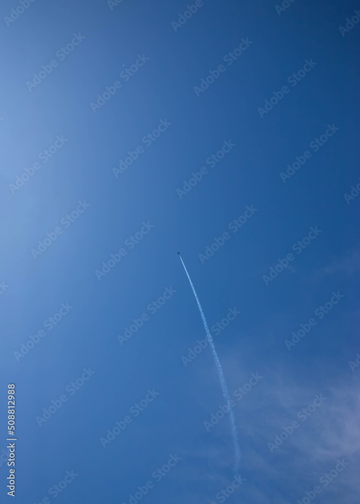 Blue sky with white clouds and a small plane left a trail place for text template Blue sky with white clouds and a small plane left a trail place for text template