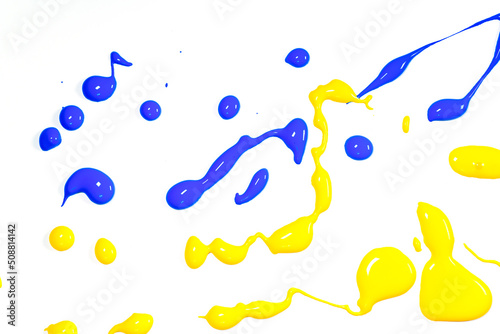 Yellow and blue paint splater reflecting the national colors of Ukraine..   Abstract image of yellow and paint splatter on white background