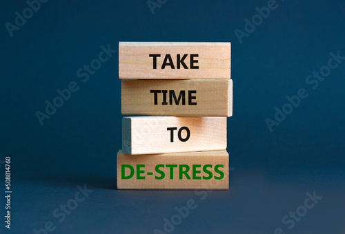 Take time to de-stress symbol. Concept words Take time to de-stress on wooden blocks. Beautiful grey table grey background. Psychological business and take time to de-stress concept. Copy space.