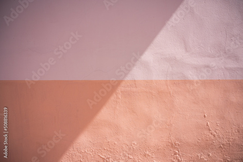 Texture background; wall painted in two different colours with a shadow over it