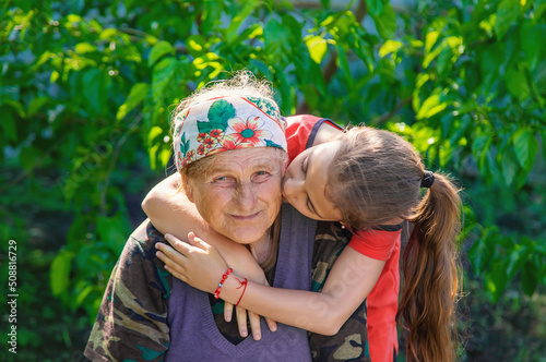 Granddaughter hugs and loves her grandmother. Selective focus.