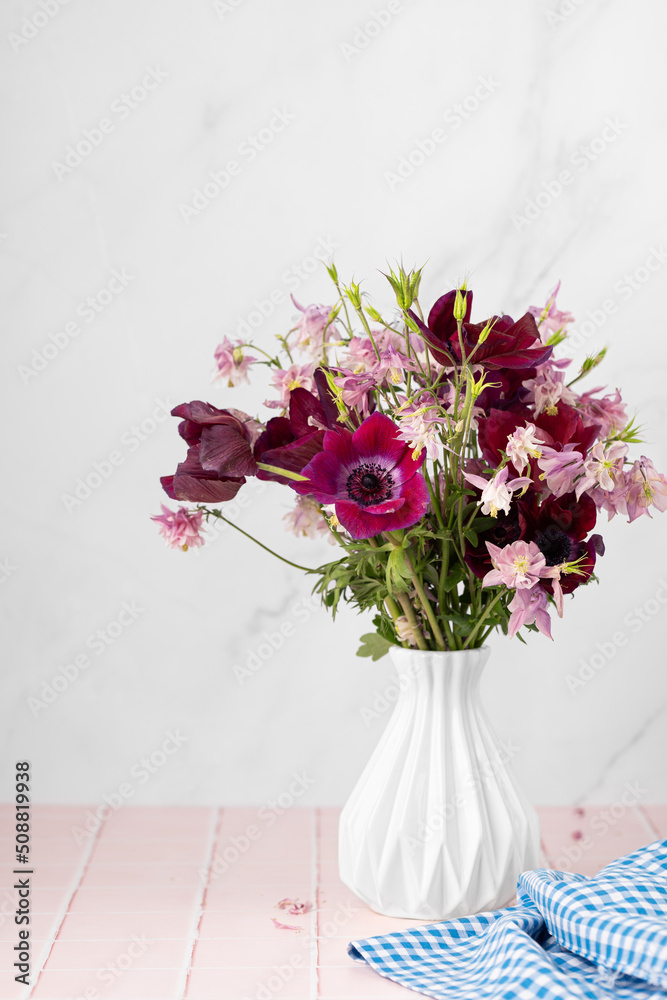 Vase with beautiful flowers bouquet on table against white background. Space for text Vase with beautiful flowers bouquet on table against white background. Space for text