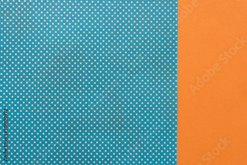 orange and blue paper background with dots