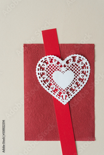 fancy doily heart on red and beige paper photo