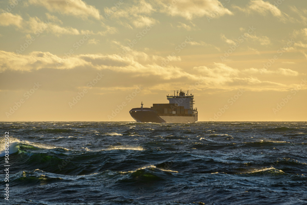 Ship at sea. Beautiful seascape  waves and sky with clouds with beautiful lighting.  Golden hour.