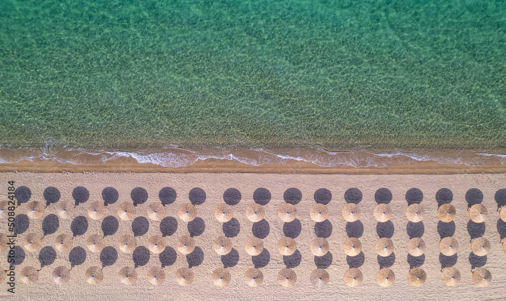 beach view from drone without people with sun umbrellas