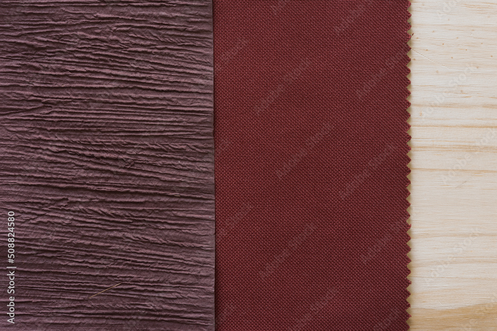Fototapeta premium textured paper, brown red fabric, and wood