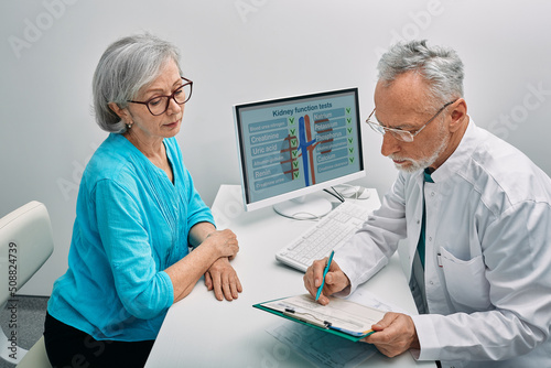 Senior woman during a consultation with a urologist about kidney disease and treatment at medical clinic. Kidneys health photo