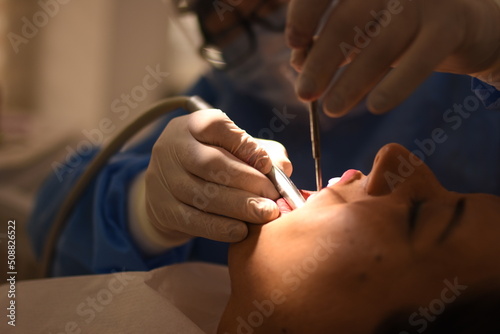 Dentist doing dental treatment with her assistant di  il 