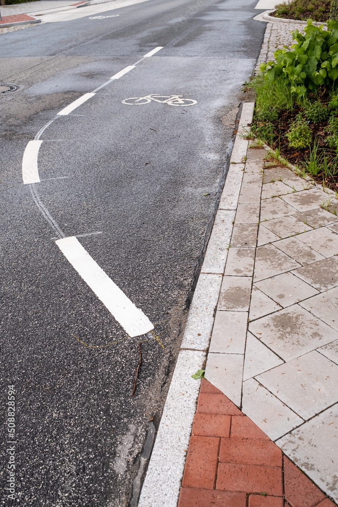 Signs on an asphalt road allowing cycling. Bike lane with symbols and dotted line. Concept of safe movement. Signs on an asphalt road allowing cycling. Bike lane with symbols and dotted line. Concept of safe movement.