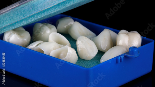 excellent composition of a blue dental case with ceramic crowns on a black background