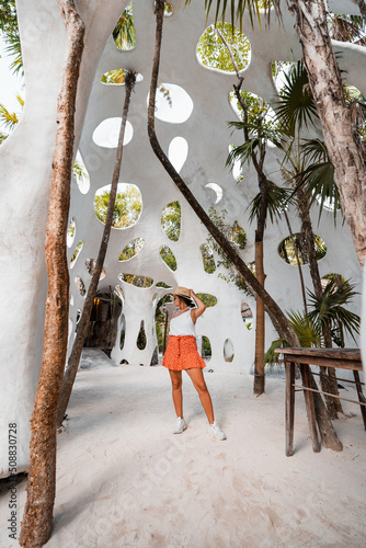 young hispanic woman tours tulum in mexico