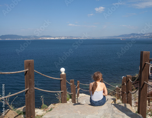 Little girl dreaming and looking at horizon skyline photo