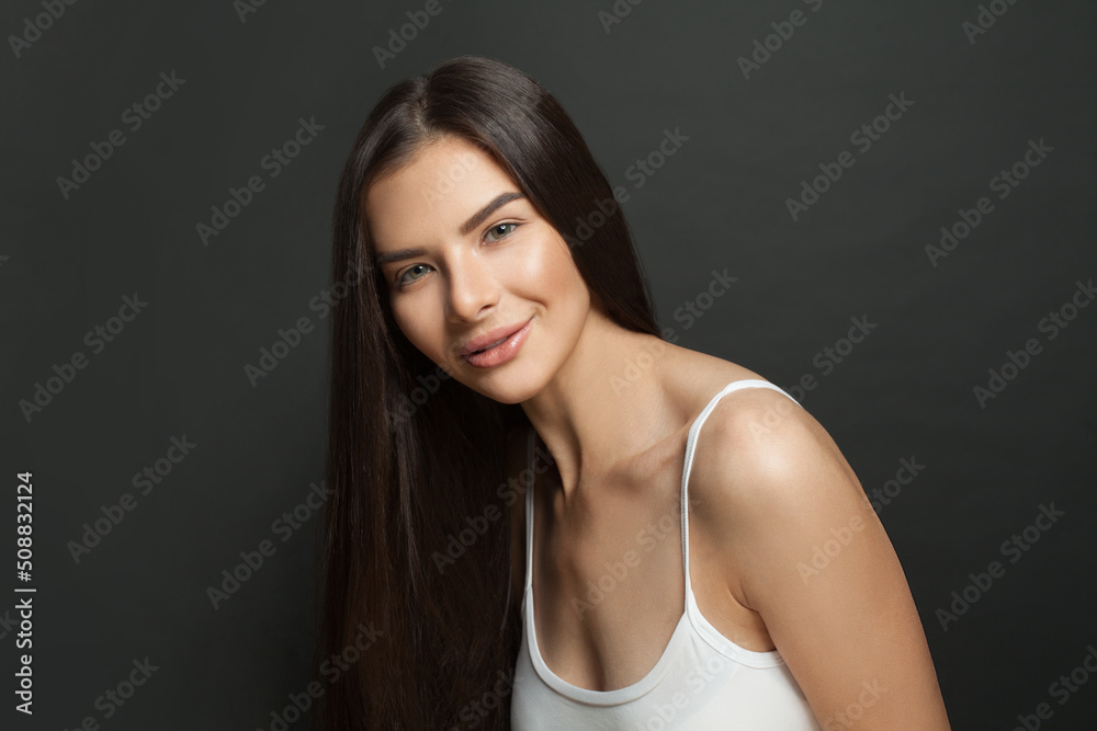 Portrait of beautiful young woman with healthy long hair on black background Portrait of beautiful young woman with healthy long hair on black background