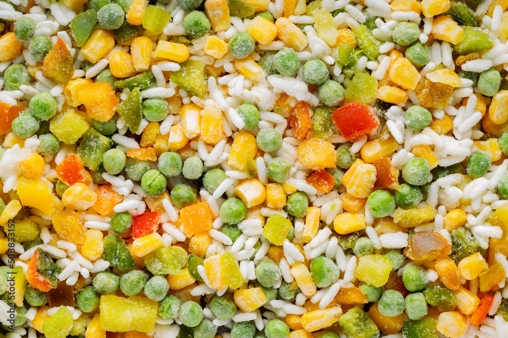 Food background with frozen vegetables with rice. Frozen vegetables retaining all nutrients: green peas, sweet corn, bell pepper. Frozen food background. Flat lay Food background with frozen vegetables with rice. Frozen vegetables retaining all nutrients: green peas, sweet corn, bell pepper. Frozen food background. Flat lay
