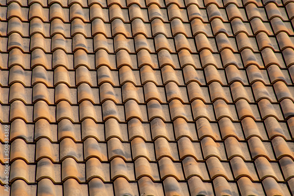 Old and weathered roof tiles creating a uniform and geometric texture typical of southeastern Spain