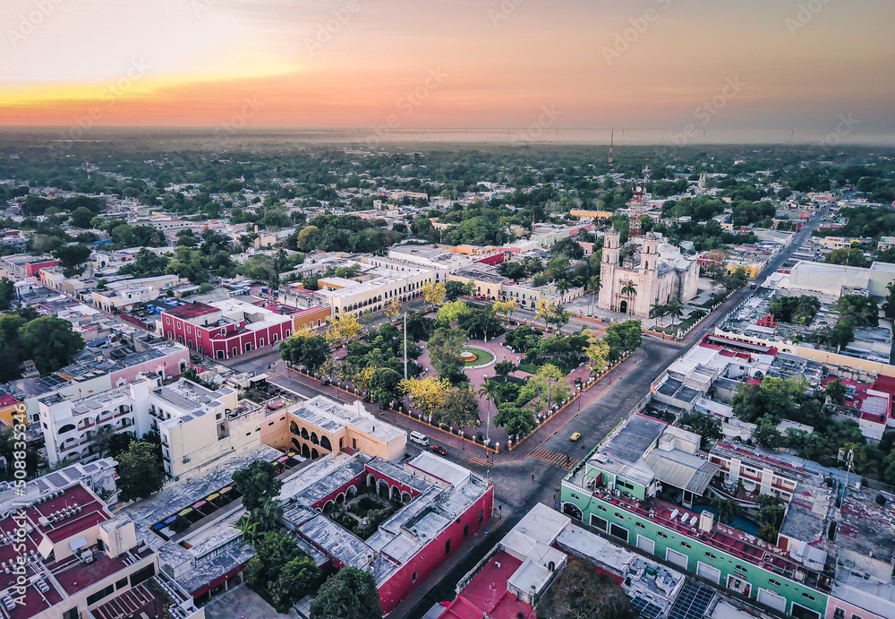 Aerial view of Valladolid Mexico City of Yucatan drone reveal the center of the town during sunset golden hour