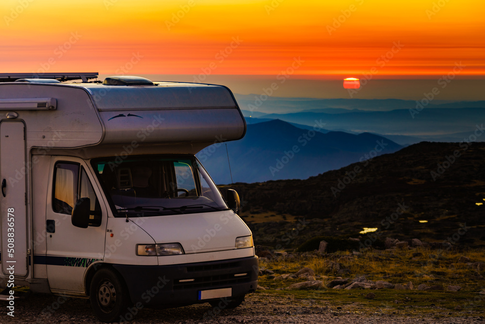 Rv camper camping in mountain at sunset. Rv camper camping in mountain at sunset.