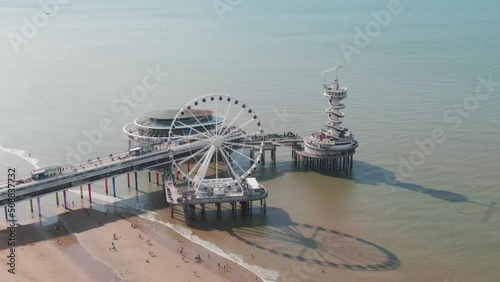 Aerial Drone Shot of the famous Scheveningen Beach Pier near The Hague, Netherlands on a sunny overcast day photo