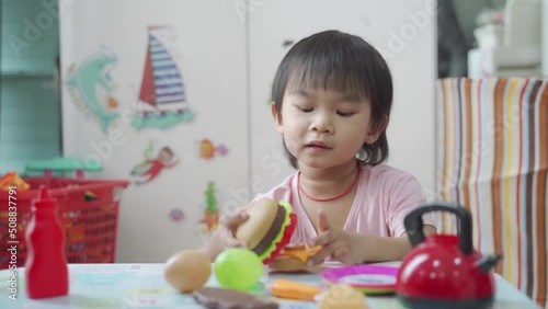 Little boy chef cooking hamburger on the table, Kids play and cook at school.