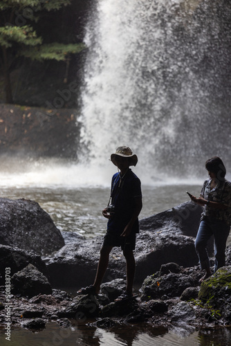 People are in the forest watching waterfalls and watching the beautiful nature playing in the water and relaxing on vacation. At Khao Yai National Park, Thailand, 16-05-2022