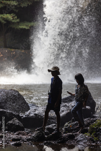People are in the forest watching waterfalls and watching the beautiful nature playing in the water and relaxing on vacation. At Khao Yai National Park, Thailand, 16-05-2022