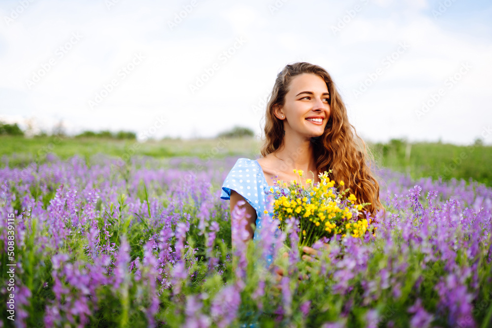 Beautiful woman in the blooming field. Nature, vacation, relax and lifestyle. Summer landscape. Beautiful woman in the blooming field. Nature, vacation, relax and lifestyle. Summer landscape.