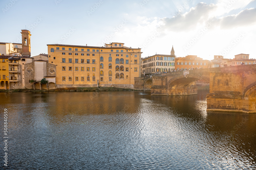 Sunset view on the riverside with old renaissance buildings in Florence, Italy. Concept of traveling Italy, visiting italian landmarks