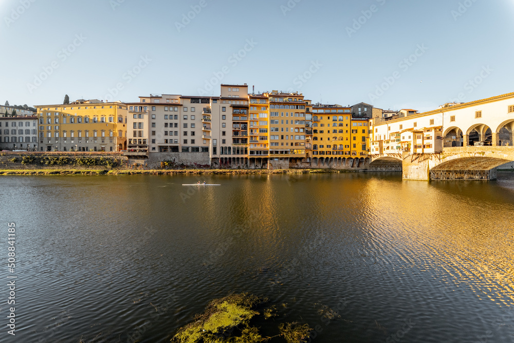 Morning view on famous Old bridge called Ponte Vecchio on Arno river in Florence, Italy. Concept of traveling Italy and visiting italian landmarks