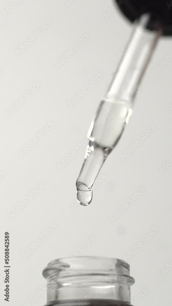 Transparent liquid drops. Dropper on white background. Transparent liquid drops. Dropper on white background.