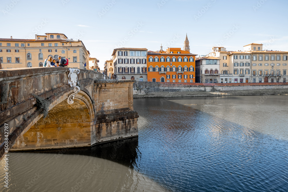Fototapeta premium Morning view on Holy Trinity Bridge and riverside of Arno river in Florence city. Travel italian cities of Tuscany. Italian Renaissance architecture