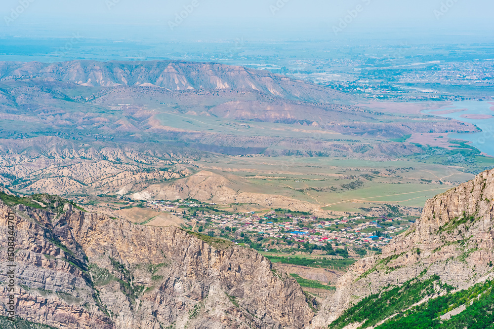 mountain landscape in the Caucasus with a view of the valley of the Sulak River and the towns below on the plain