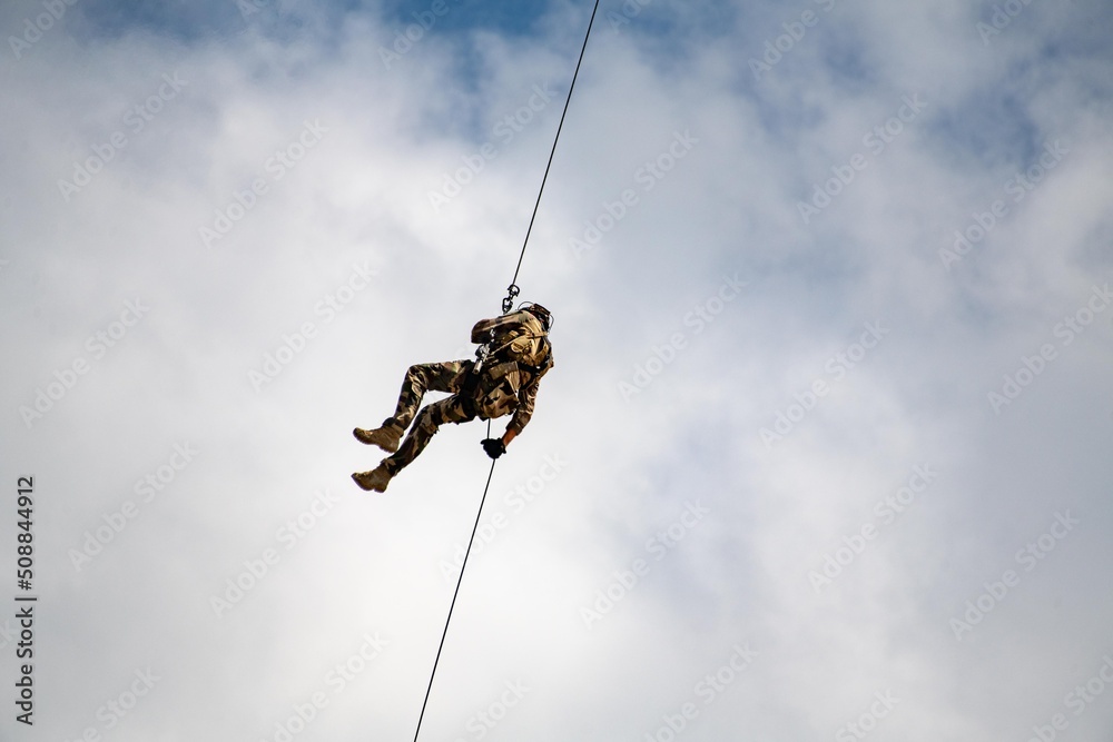 The military landing descends on a rope
