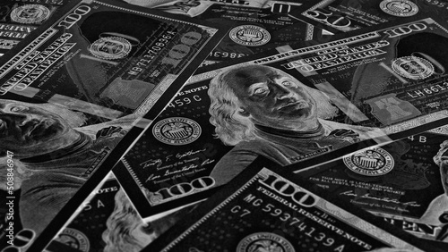American paper money. 100 dollar and other US notes. Black and white wallpaper or background. Savings economy and the USA dollar. Dark inverted photos. Fed and federal funds rate photo