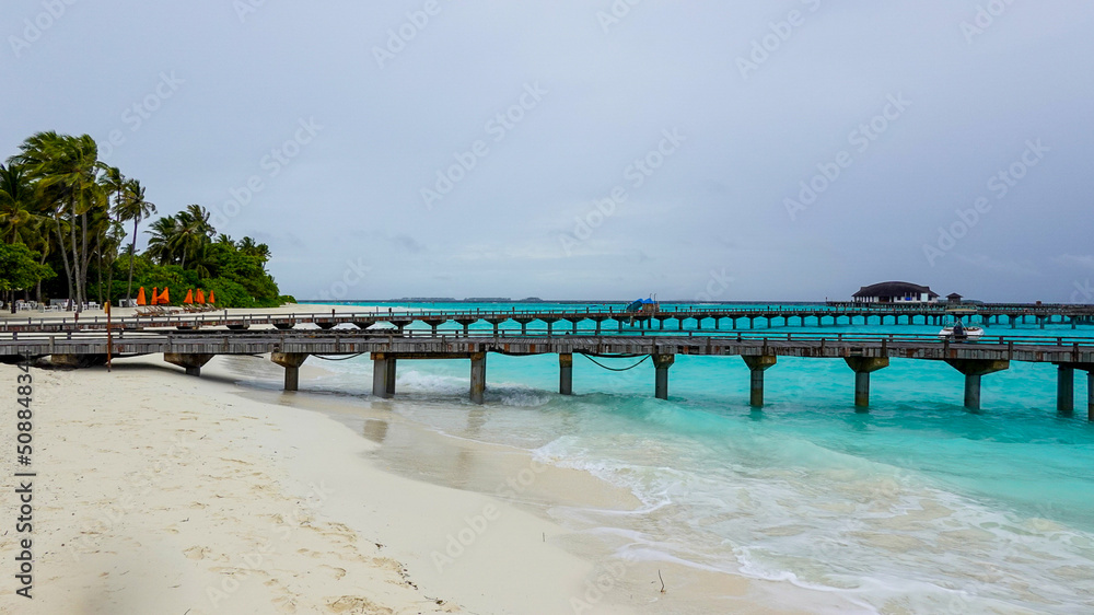 beautiful view of the tropical beach with wooden bridge 