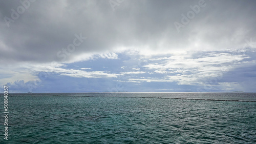 view of an ocean  turquoise water with cloudy sky