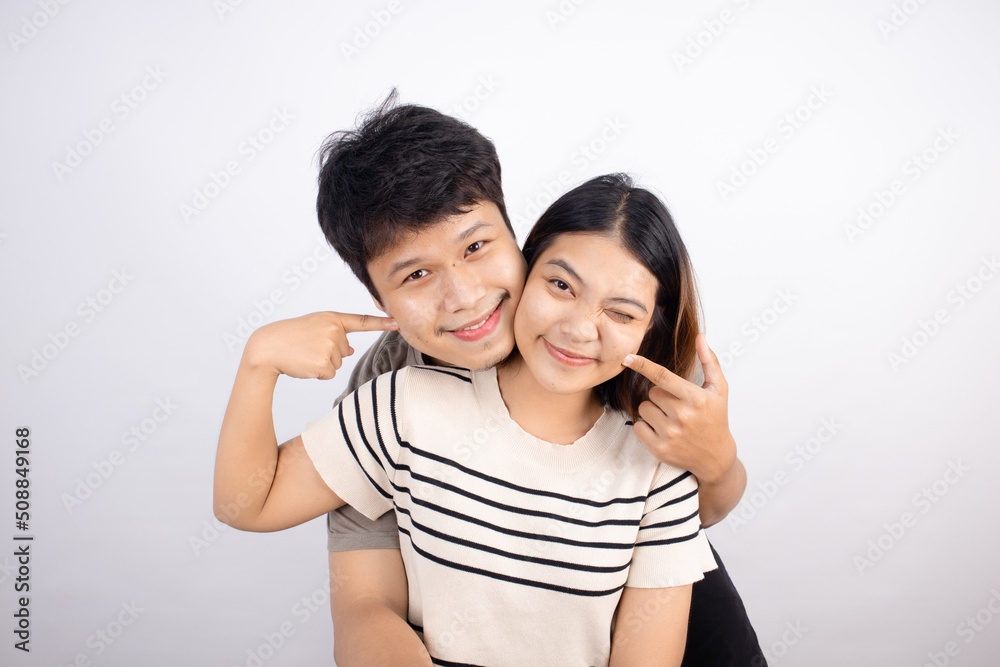 Asian couple happy and fun gesturing cute emoticons on white background. Asian couple happy and fun gesturing cute emoticons on white background.