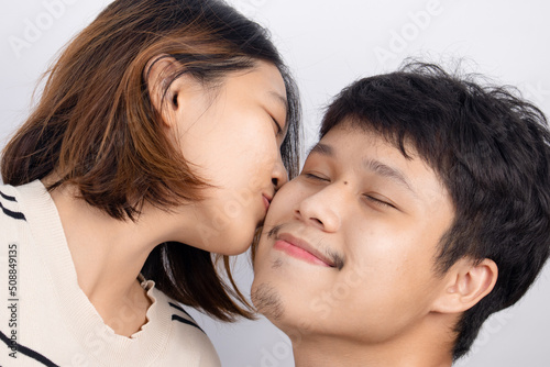 Asian couple happy and fun gesturing cute emoticons on white background.