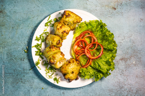Vászonkép Chicken Green Hariyali tikka boti platter with lime and salad in a dish top view