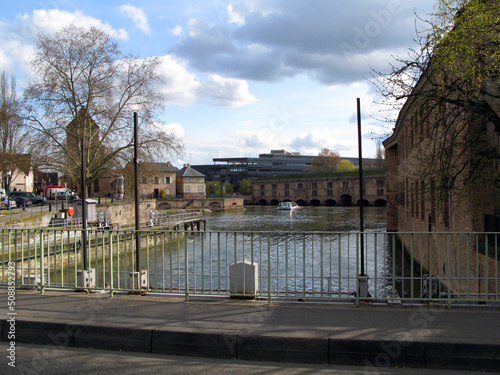 View from the bridge over the river Ile in Strasbourg to the fortress, old houses, blossoming leaves on the trees, historical site, April 2009, spring, France,