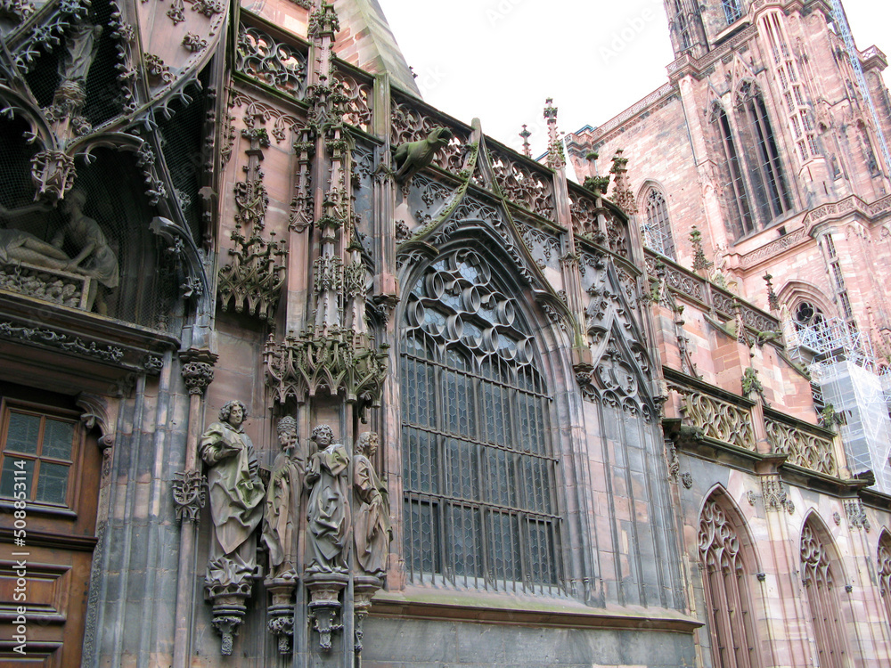 Naklejka premium The main cathedral of Strasbourg France. Romanesque and gothic architecture style. Most famous Catholic cathedrals. design details, stone carving, statues, columns. April 2009.